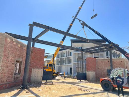 Mobile crane lifting a steel beam into place